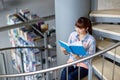 High school student girl reading book at library Royalty Free Stock Photo