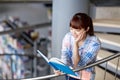 High school student girl reading book at library Royalty Free Stock Photo