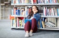 High school student girl reading book at library Royalty Free Stock Photo