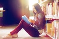 High school student girl reading book at library Royalty Free Stock Photo