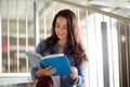 High school student girl reading book at library Royalty Free Stock Photo