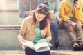 High school student girl reading book outdoors Royalty Free Stock Photo