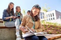 High school student girl reading book outdoors Royalty Free Stock Photo