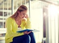 High school student girl reading book on stairs Royalty Free Stock Photo