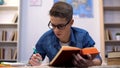 High school student in glasses doing his homework , hard educational program Royalty Free Stock Photo