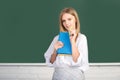 High school student learning english or mathematics in class. Female student taking notes from a book in college Royalty Free Stock Photo