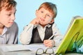 A high school student prepares a first grader in writing and preparing for school. Older brother teaches younger