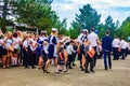 High school students lead boys and girls enrolled in the first class with a solemn line on the day of knowledge to school