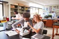 High School Students Looking Through Microscope In Biology Class