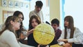 High school students looking at the yellow globe of the moon.