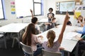 High School Students Raising Hands To Answer Question Set By Teacher In Classroom Royalty Free Stock Photo