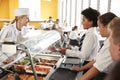 High School Students Wearing Uniform Being Served Food In Canteen