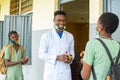 High school teacher dispensing hand sanitizer for school kid Royalty Free Stock Photo