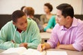High School Teacher Helping Student With Written Work Royalty Free Stock Photo