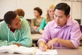 High School Teacher Helping Student With Written Work Royalty Free Stock Photo
