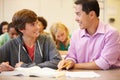 High School Teacher Helping Student With Written Work Royalty Free Stock Photo