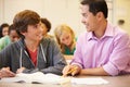 High School Teacher Helping Student With Written Work Royalty Free Stock Photo