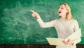 High school teacher near chalkboard in classroom. Happy female teacher giving lesson to students in school or university Royalty Free Stock Photo