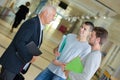 High school teacher talking to students in corridor Royalty Free Stock Photo