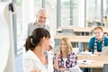 High school - three students with mature professor Royalty Free Stock Photo