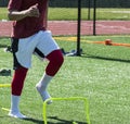 Running over mini hurdles on turf field Royalty Free Stock Photo