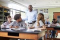 High School Tutor With Digital Tablet Teaching Students In Biology Class Royalty Free Stock Photo