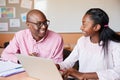 High School Tutor Giving Female Student One To One Tuition At Desk Royalty Free Stock Photo