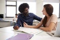 High School Tutor Giving Female Student One To One Tuition At Desk In Classroom Royalty Free Stock Photo