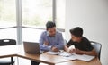 High School Tutor Giving Male Student With Laptop One To One Tuition At Desk