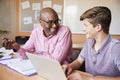 High School Tutor Giving Male Student One To One Tuition At Desk Royalty Free Stock Photo