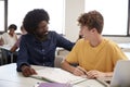High School Tutor Giving Male Student One To One Tuition At Desk In Classroom Royalty Free Stock Photo