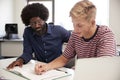 High School Tutor Giving Male Student One To One Tuition At Desk In Classroom Royalty Free Stock Photo