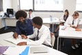 High School Tutor Giving Uniformed Male Student One To One Tuition At Desk In Classroom Royalty Free Stock Photo