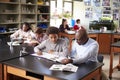 High School Tutor Sitting At Desk With Male Student In Biology Class Royalty Free Stock Photo