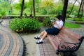 High-Schoolgirl reading in the park