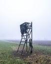 high seat for hunting in green winter field near utrecht in the netherlands on misty winter day Royalty Free Stock Photo