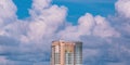 High section of modern skyscraper hotel against big rain clouds on blue sky background before raining Royalty Free Stock Photo