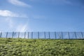 Security: Woven wire security fencing topped with razor wire. 5 Royalty Free Stock Photo