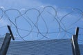 Security: Woven wire security fencing topped with razor wire. 3 Royalty Free Stock Photo