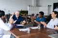 High-skilled mixed race medical people celebrating in hospital office successful victory. Royalty Free Stock Photo