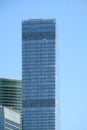 Tower building with panoramic windows in modern city office business center over clear cloudless blue sky vertical view Royalty Free Stock Photo