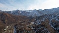 High snowy peaks stand in the distance. Drone view