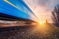 High speed blue passenger train on railroad track in motion