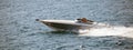 High-speed boat goes fast in calm sea. People enjoy the summer sport. Panoramic view, banner. Royalty Free Stock Photo