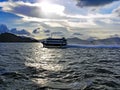 A high-speed ferry rides in the evening across the sea from Hong Kong Island to Macau