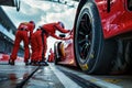 High-speed Formula One race car changing tires in pit stop during intense competition