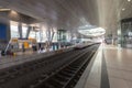 High-speed ICE train at the airport's long-distance station with people waiting on the platform Royalty Free Stock Photo