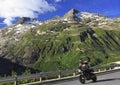 High speed motorcycle passing on Furka Pass road in Switzerland Alps