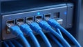 High-Speed Network Connectivity: Blue Ethernet Cables Plugged into a Server Rack Royalty Free Stock Photo