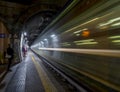 High-speed night train passing through a train station Royalty Free Stock Photo